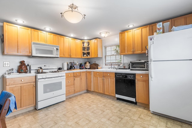 45 W 23rd St, Deer Park, NY 11729 - kitchen with white appliances, light floors, tile countertops, glass insert cabinets, and a sink