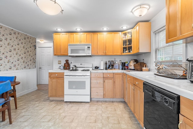 45 W 23rd St, Deer Park, NY 11729 - kitchen featuring white appliances, a wainscoted wall, tile counters, wallpapered walls, and glass insert cabinets