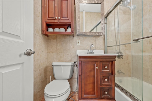 21-38 73rd St, Astoria, NY 11370 - bathroom featuring vanity, toilet, tile walls, and combined bath / shower with glass door