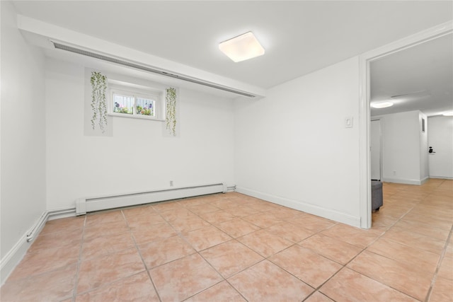 21-38 73rd St, Astoria, NY 11370 - unfurnished room with baseboard heating, light tile patterned floors, and baseboards