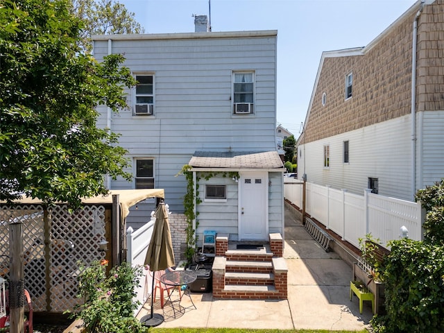 21-38 73rd St, Astoria, NY 11370 - back of property with a fenced backyard, a patio, a chimney, and cooling unit