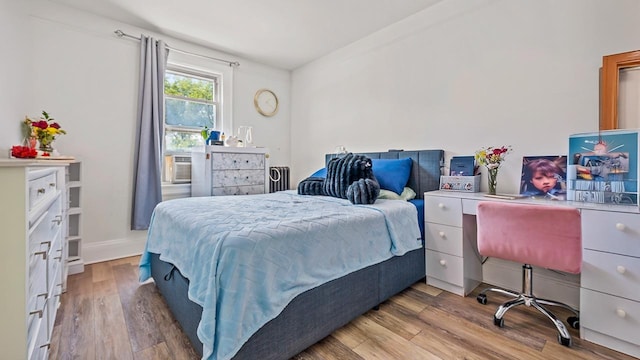 21-38 73rd St, Astoria, NY 11370 - bedroom featuring wood finished floors, an office area, and cooling unit