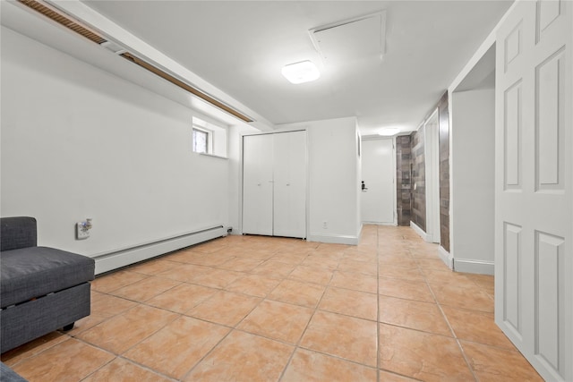 21-38 73rd St, Astoria, NY 11370 - basement featuring a baseboard heating unit and light tile patterned floors