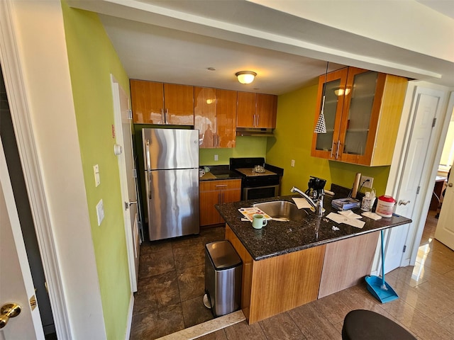 6422 Bay Pkwy Unit 3A, Brooklyn, NY 11204 - kitchen with stainless steel appliances, under cabinet range hood, a peninsula, brown cabinetry, and glass insert cabinets