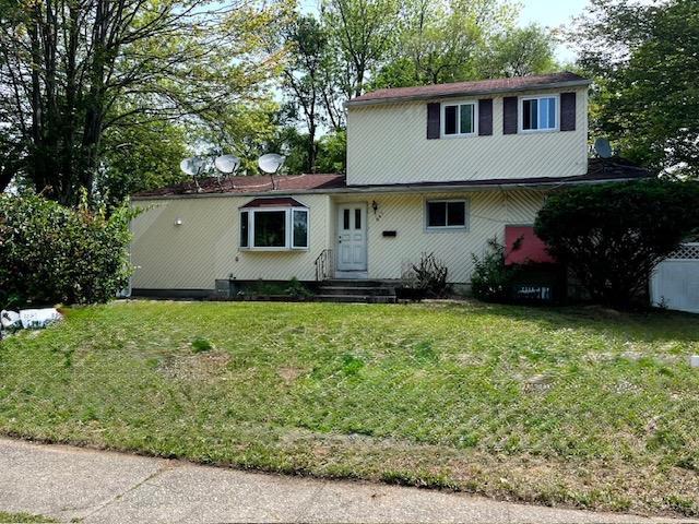 587 Freeman Ave, Brentwood, NY 11717 - traditional-style home featuring a front yard