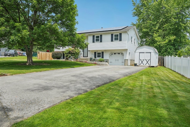 304 Cloverdale Ct, New Windsor, NY 12553 - view of front of home featuring roof mounted solar panels, asphalt driveway, a storage unit, and an attached garage