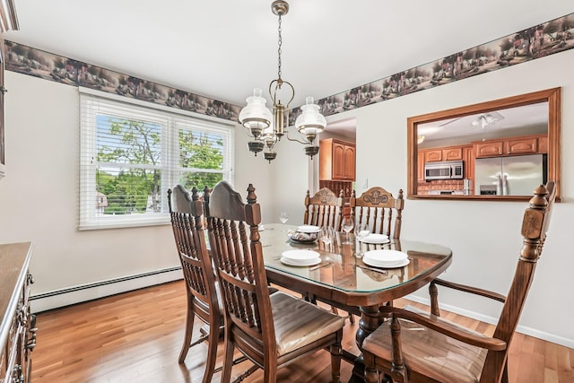 304 Cloverdale Ct, New Windsor, NY 12553 - dining area with baseboard heating, light wood finished floors, and a chandelier