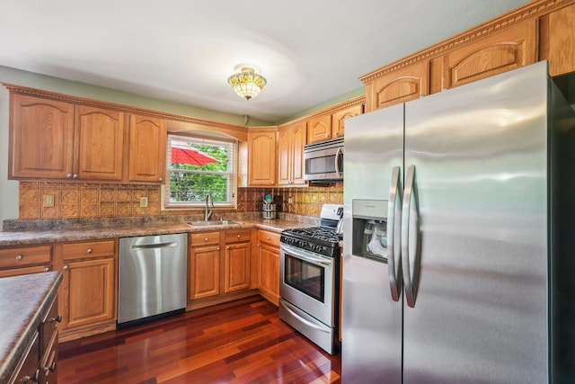 304 Cloverdale Ct, New Windsor, NY 12553 - kitchen featuring stainless steel appliances, dark wood-type flooring, decorative backsplash, and brown cabinetry