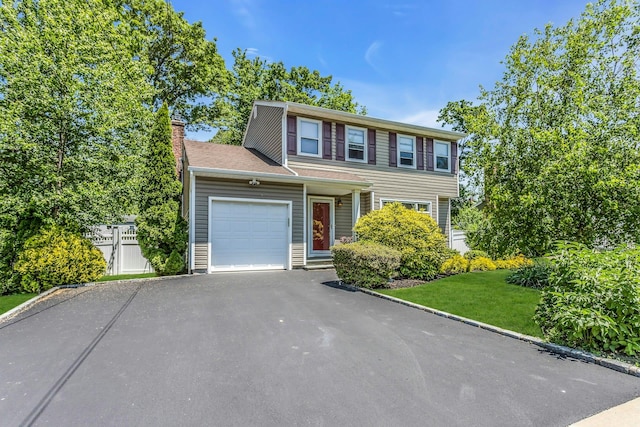 14 Troy Ct, Northport, NY 11768 - view of front of house featuring a garage, driveway, and a chimney