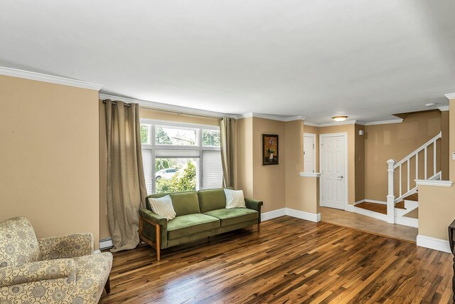 14 Troy Ct, Northport, NY 11768 - living room with wood finished floors, stairs, crown molding, baseboards, and a baseboard radiator