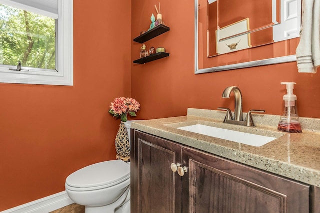 14 Troy Ct, Northport, NY 11768 - bathroom featuring vanity, toilet, and baseboards