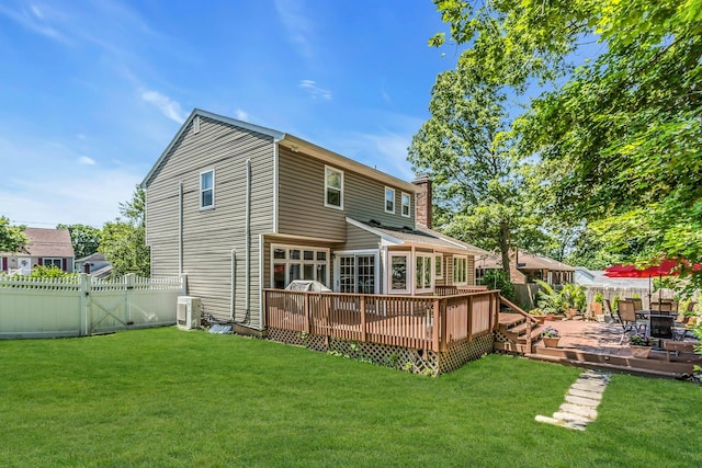 14 Troy Ct, Northport, NY 11768 - back of property with a deck, a gate, ac unit, and a chimney