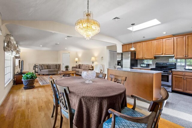 20407 29th Ave, Bayside, NY 11360 - dining space with vaulted ceiling, a chandelier, a skylight, light wood-style flooring, and recessed lighting