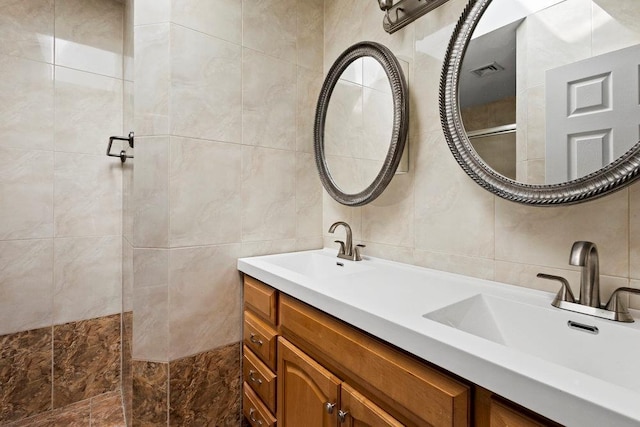 20407 29th Ave, Bayside, NY 11360 - bathroom with tile walls, tiled shower, double vanity, and decorative backsplash