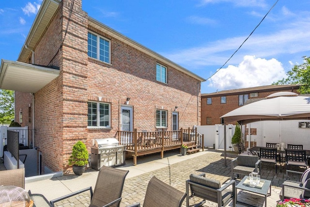 20407 29th Ave, Bayside, NY 11360 - rear view of property featuring an outdoor living space, a patio, brick siding, a deck, and a gate