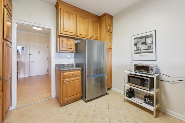 16 Rockledge Unit 3L-1, Ossining, NY 10562 - kitchen with appliances with stainless steel finishes, light tile patterned flooring, crown molding, brown cabinets, and baseboards