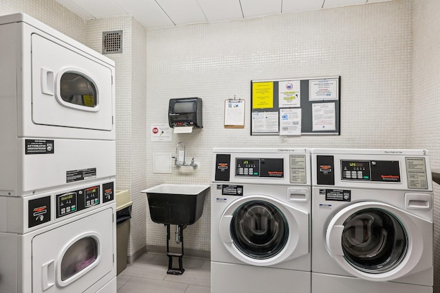 16 Rockledge Unit 3L-1, Ossining, NY 10562 - community laundry featuring stacked washer / drying machine, washing machine and dryer, and light tile patterned floors