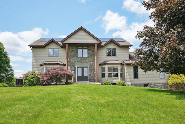 30 Sunrise Rdg, Florida, NY 10921 - view of front of house featuring french doors, a front lawn, roof mounted solar panels, and stone siding