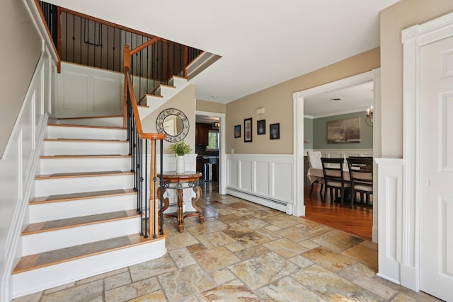 30 Sunrise Rdg, Florida, NY 10921 - stairs featuring a baseboard radiator, stone tile floors, a wainscoted wall, and a decorative wall