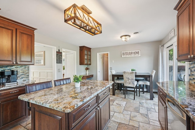 30 Sunrise Rdg, Florida, NY 10921 - kitchen featuring stone tile floors, stainless steel dishwasher, light stone counters, a kitchen island, and pendant lighting