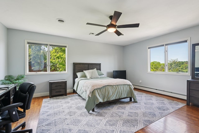 30 Sunrise Rdg, Florida, NY 10921 - bedroom with a baseboard radiator, multiple windows, wood finished floors, and an office area