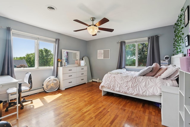 30 Sunrise Rdg, Florida, NY 10921 - bedroom with wood finished floors, a baseboard radiator, and ceiling fan