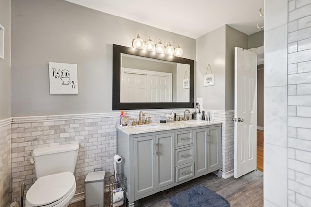30 Sunrise Rdg, Florida, NY 10921 - full bathroom with tile walls, wainscoting, double vanity, wood finished floors, and toilet
