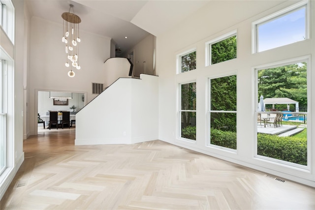3 Sugar Maple Ct, Dix Hills, NY 11746 - interior space featuring a towering ceiling, plenty of natural light, a chandelier, and stairs