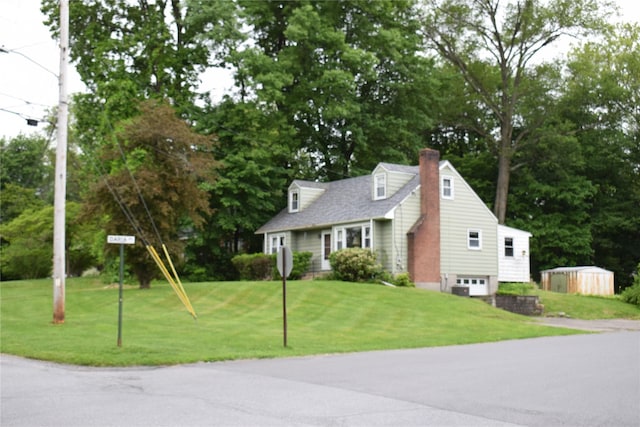 25 Alda Dr, Poughkeepsie, NY 12603 - view of front facade featuring a chimney, driveway, a front lawn, an attached garage, and view of wooded area