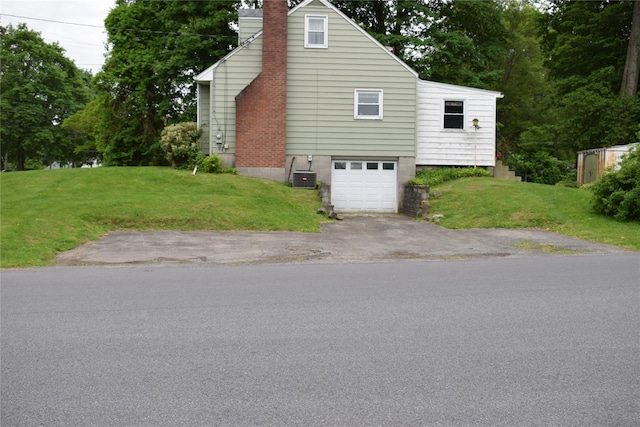 25 Alda Dr, Poughkeepsie, NY 12603 - view of property exterior featuring a chimney, driveway, a lawn, and a garage