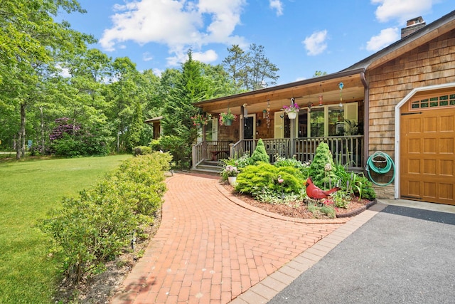 8 Jackson Ave, Hampton Bays, NY 11946 - doorway to property featuring covered porch, a lawn, a garage, a chimney, and driveway