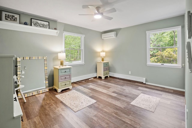 8 Jackson Ave, Hampton Bays, NY 11946 - bedroom with an AC wall unit, a baseboard heating unit, wood finished floors, and baseboards