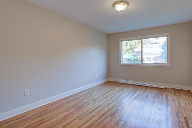 2 Goldwin St, Rye, NY 10580 - empty room with a baseboard heating unit, light wood-type flooring, and baseboards