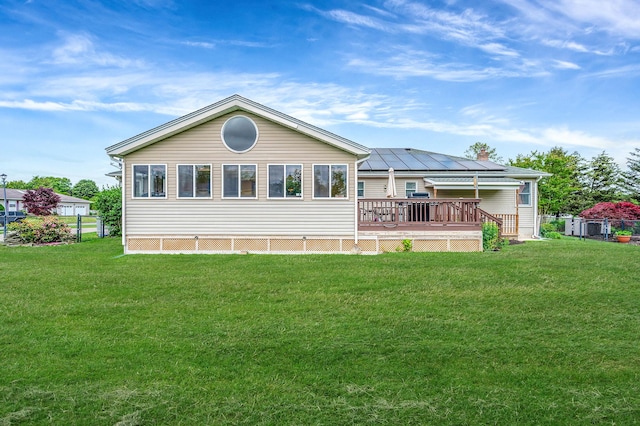 320 Williams Way S, Baiting Hollow, NY 11933 - back of property with a deck, a yard, a chimney, and solar panels