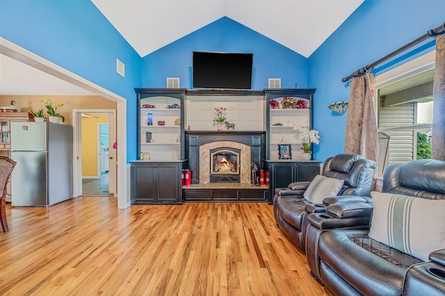 320 Williams Way S, Baiting Hollow, NY 11933 - living area featuring a tiled fireplace, wood finished floors, and high vaulted ceiling