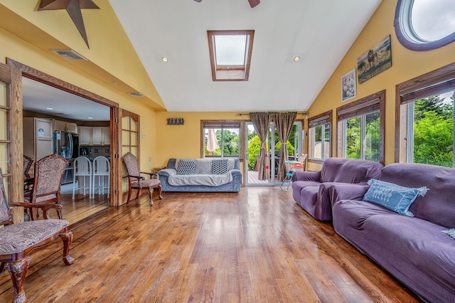 320 Williams Way S, Baiting Hollow, NY 11933 - living room featuring light wood-style floors, healthy amount of natural light, high vaulted ceiling, a ceiling fan, and a skylight