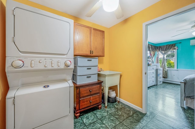320 Williams Way S, Baiting Hollow, NY 11933 - laundry room featuring stacked washer / dryer, ceiling fan, a baseboard radiator, cabinet space, and baseboards