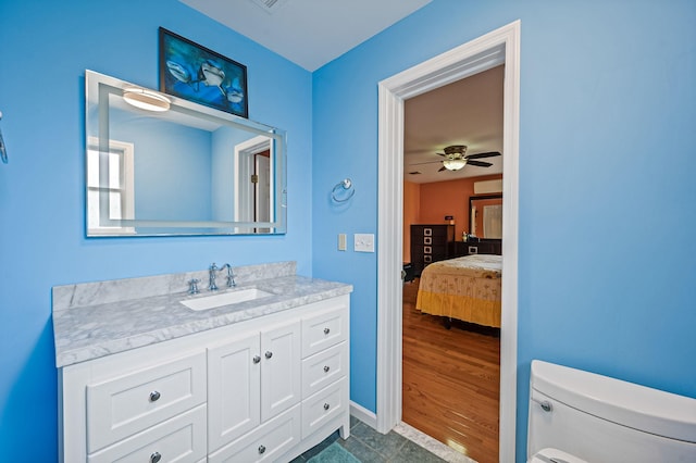 320 Williams Way S, Baiting Hollow, NY 11933 - ensuite bathroom with toilet, vanity, a ceiling fan, and baseboards