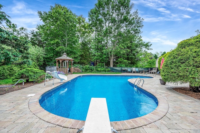 320 Williams Way S, Baiting Hollow, NY 11933 - view of swimming pool featuring a gazebo, a diving board, a water slide, a patio, and view of wooded area