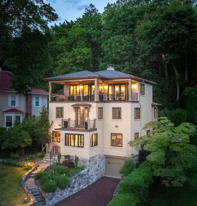 28 Buena Vista Dr, Hastings-On-Hudson, NY 10706 - back of property featuring a balcony, an attached garage, stucco siding, and a chimney