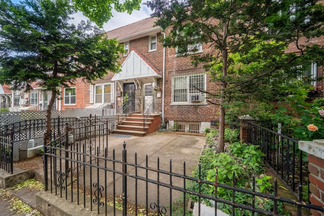 32-23 76th St, East Elmhurst, NY 11370 - tudor home with brick siding and a fenced front yard