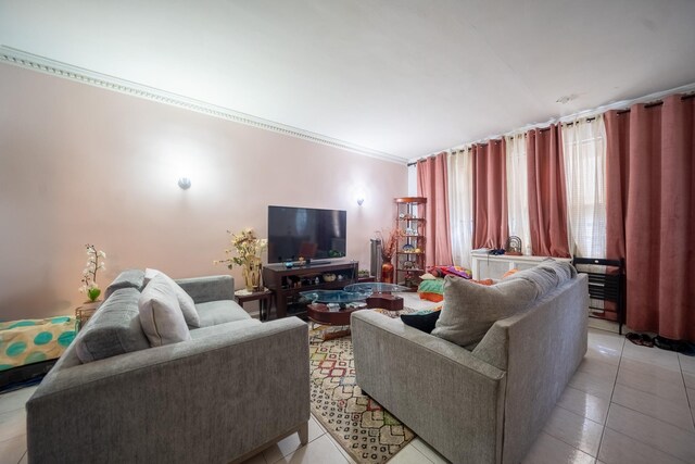 32-23 76th St, East Elmhurst, NY 11370 - living area featuring light tile patterned floors and crown molding