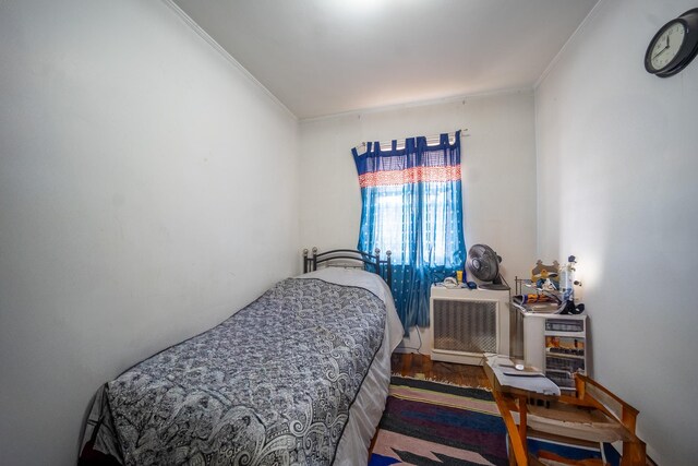 32-23 76th St, East Elmhurst, NY 11370 - bedroom with ornamental molding and wood finished floors
