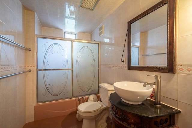 32-23 76th St, East Elmhurst, NY 11370 - full bath featuring tile walls, enclosed tub / shower combo, vanity, and toilet