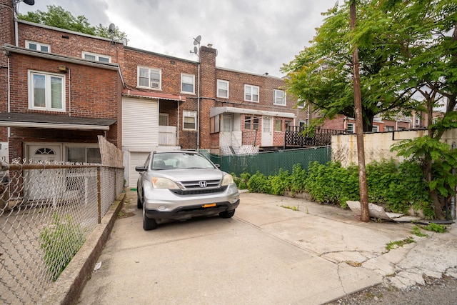 32-23 76th St, East Elmhurst, NY 11370 - view of front facade featuring brick siding and a chimney