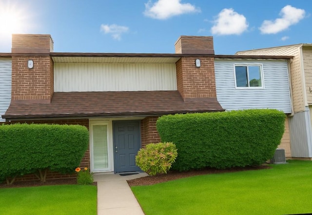 79 S Pointe Cir S Unit 79, Coram, NY 11727 - view of front of property featuring a chimney and a front lawn
