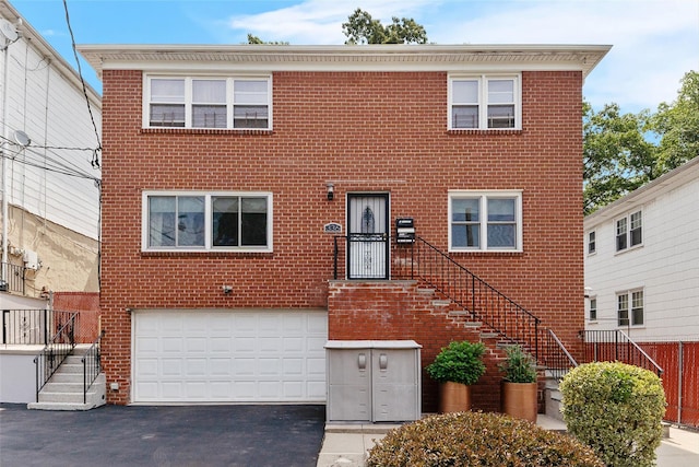 336 Mile Square Rd, Yonkers, NY 10701 - multi unit property featuring an attached garage, asphalt driveway, brick siding, and stairway