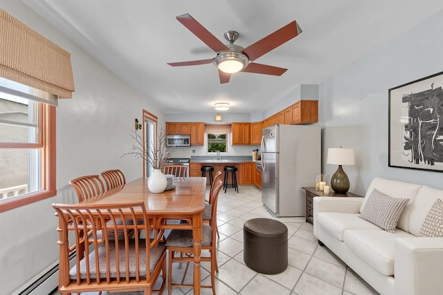336 Mile Square Rd, Yonkers, NY 10701 - dining space featuring a ceiling fan, light tile patterned floors, and a baseboard heating unit