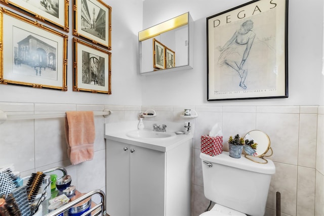 336 Mile Square Rd, Yonkers, NY 10701 - half bathroom with tile walls, vanity, toilet, and wainscoting