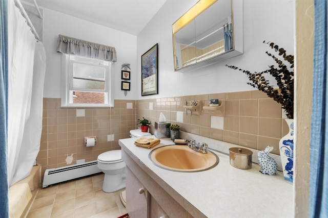 336 Mile Square Rd, Yonkers, NY 10701 - bathroom featuring a baseboard heating unit, toilet, vanity, tile walls, and wainscoting